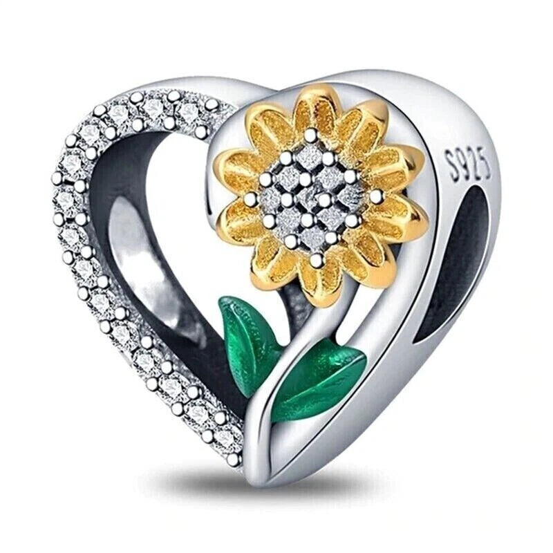Sterling silver heart charm pendant with gold sunflower center and green enamel leaves