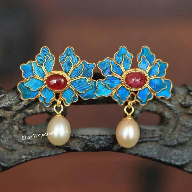 Floral cloisonne drop earrings with blue enamel petals, red center, and pearl dangles