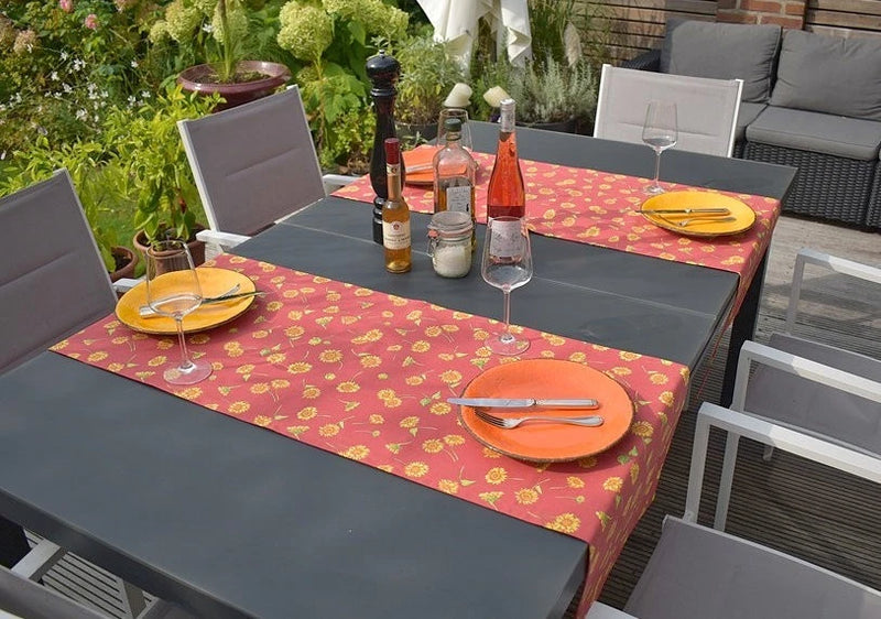 Terracotta cotton table runner with all-over sunflower pattern, rectangular shape