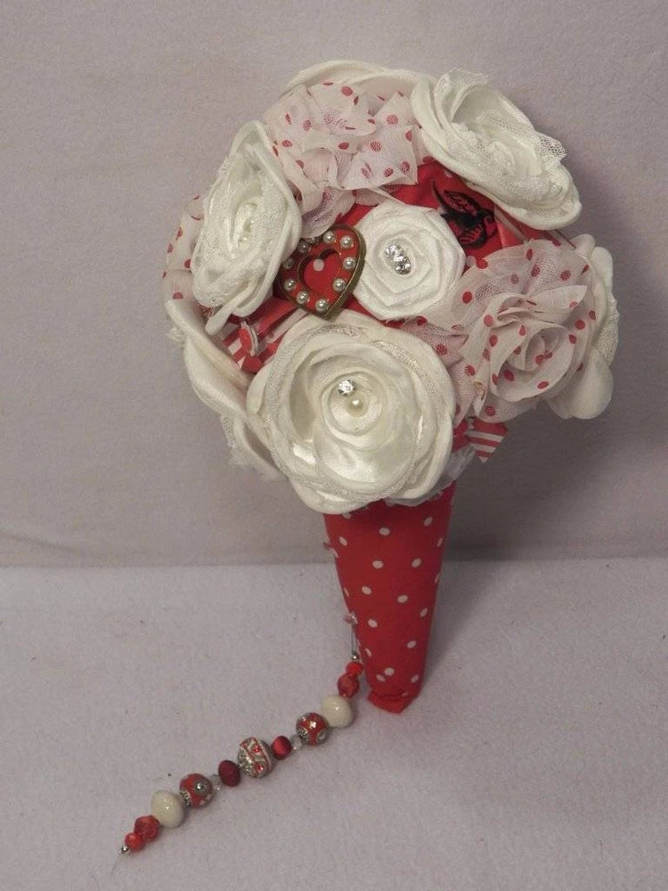 Wedding bridal bouquet with red polka-dot wrap, white fabric roses, and beaded ribbon handle