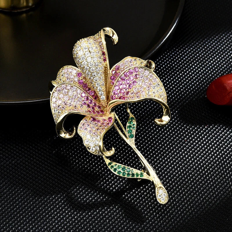 Lily flower brooch pin with gold-tone setting and pink, green, and clear stones