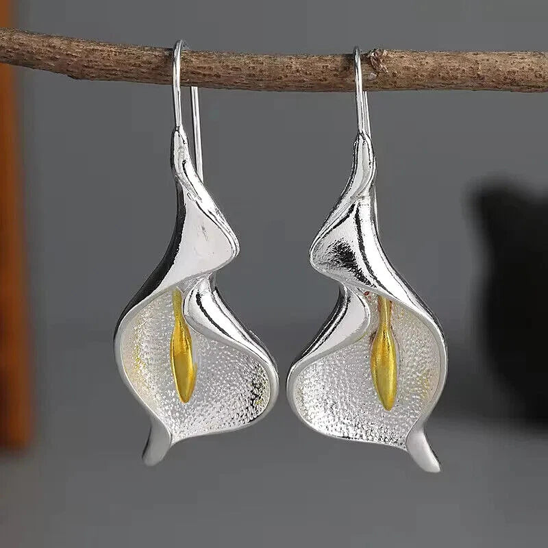 Silver calla lily dangle earrings with yellow stamen accents, curved drop flowers on hooks