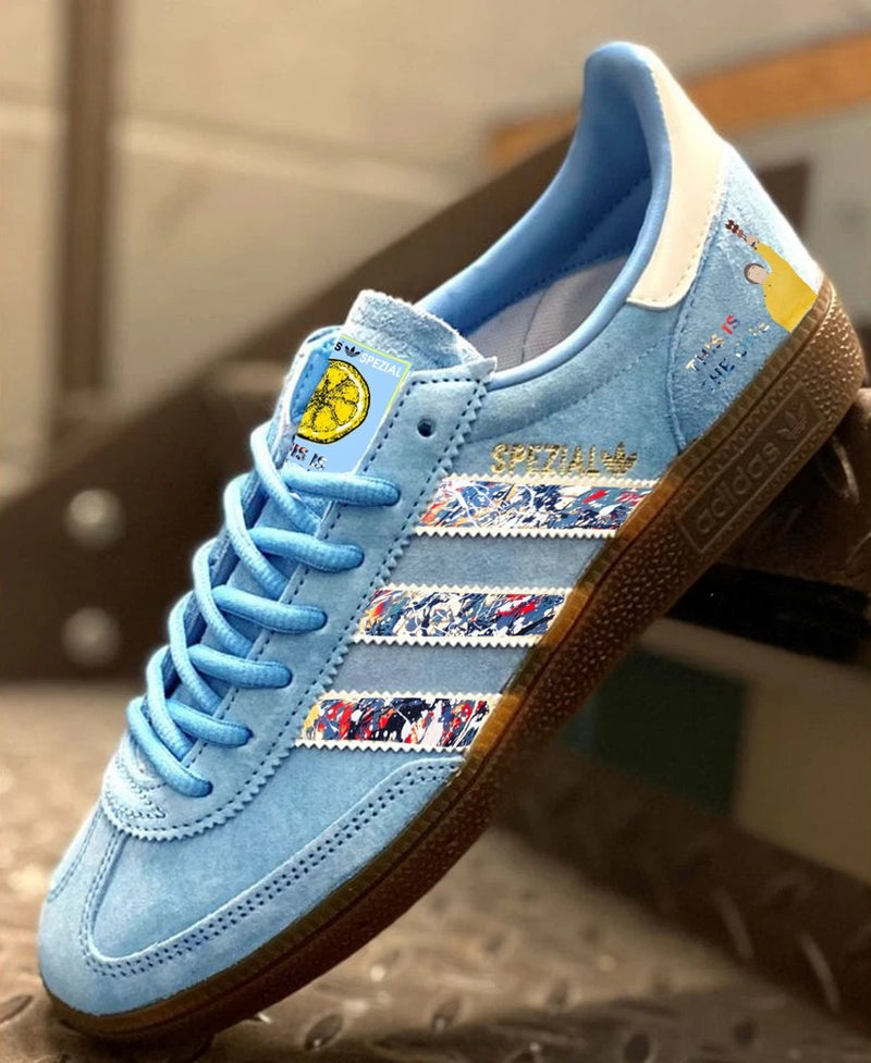 Blue Adidas Spezial trainers with custom multicolor stripe detail and gum sole