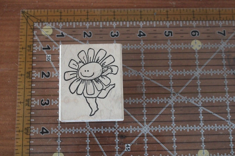 Rubber stamp featuring a smiling sunflower character in a dancing pose.