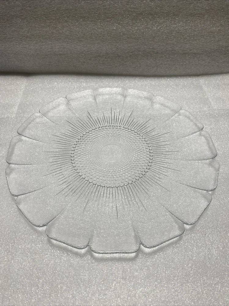 Clear glass dinner plate with embossed floral bouquet center and petal-like rim