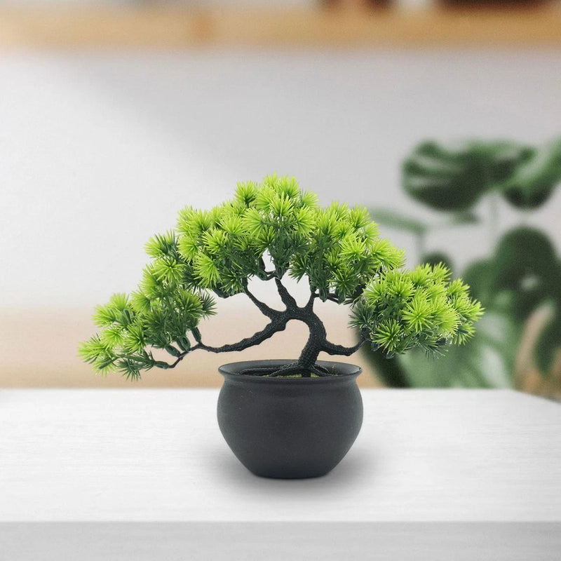 Artificial bonsai tree with bright green needle-like foliage in matte black pot