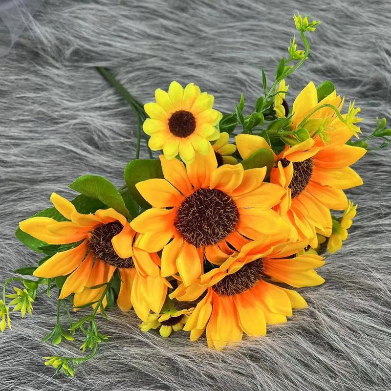 Artificial sunflower bouquet with yellow and orange blooms and green leaves