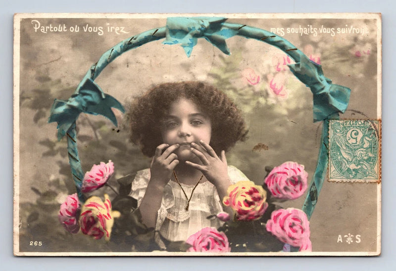 Hand-colored French portrait postcard of curly-haired flower girl with pink flowers and teal bow