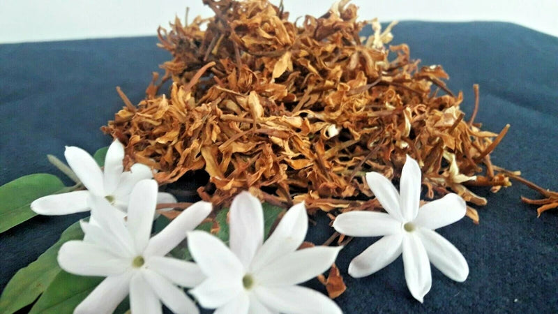 Dried jasmine flowers with white blossoms and brown dried petals for aromatherapy
