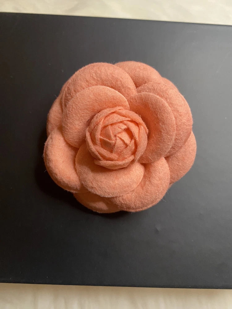 Peach flower brooch pin with layered fabric petals and small metal pin backing