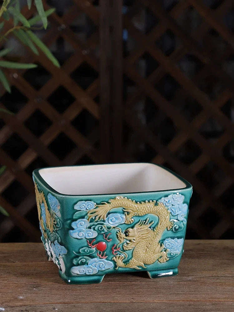 Colorful ceramic Chinese bonsai pot with teal body, gold dragon and blue cloud patterns