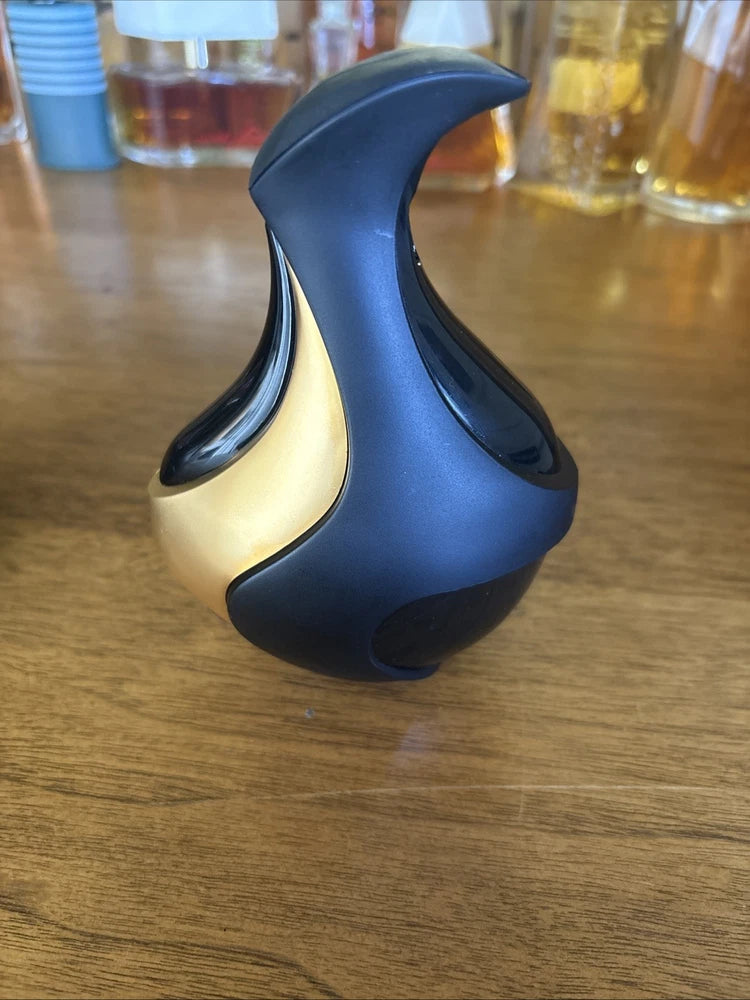 Blue and black sculpted perfume spray bottle with glossy curved shape