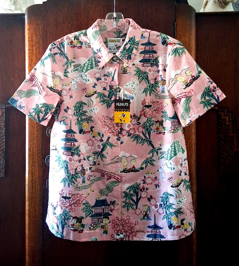 Women’s pink short-sleeve button-front shirt with collared neckline and colorful Peanuts Japan print