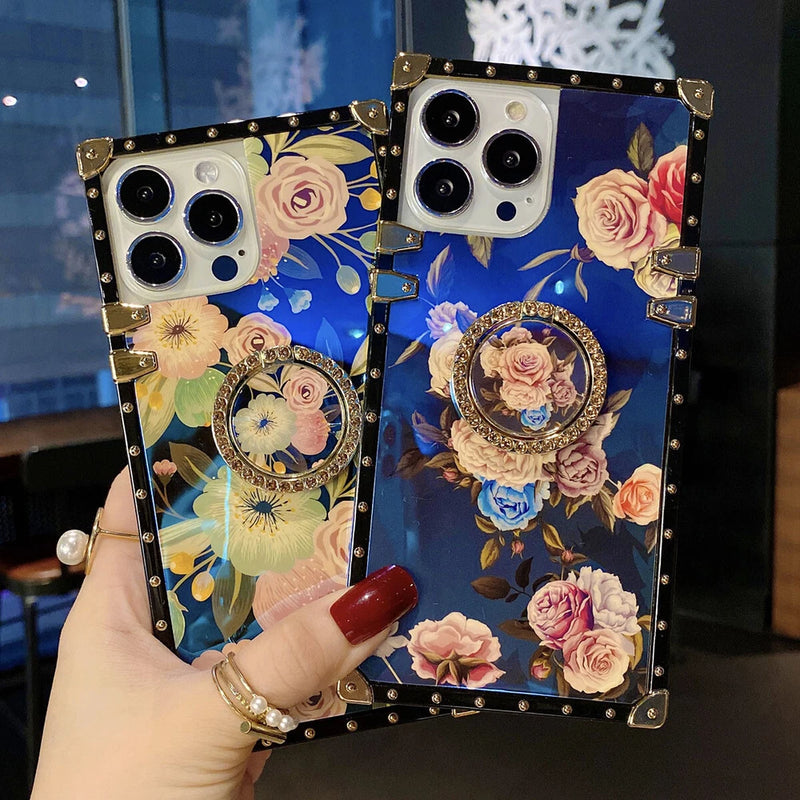 Blue floral phone case with gold studs, corner guards, and round decorative medallion