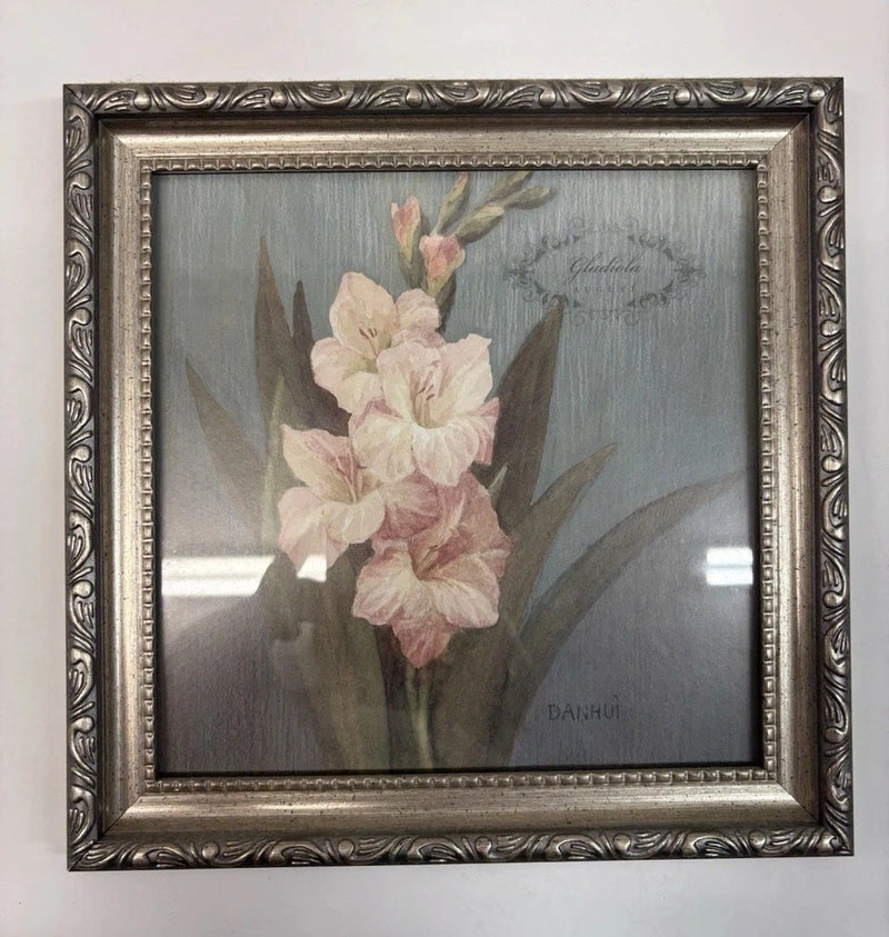 Framed shadow box with pale pink and cream dried gladiola flowers in an ornate metal frame