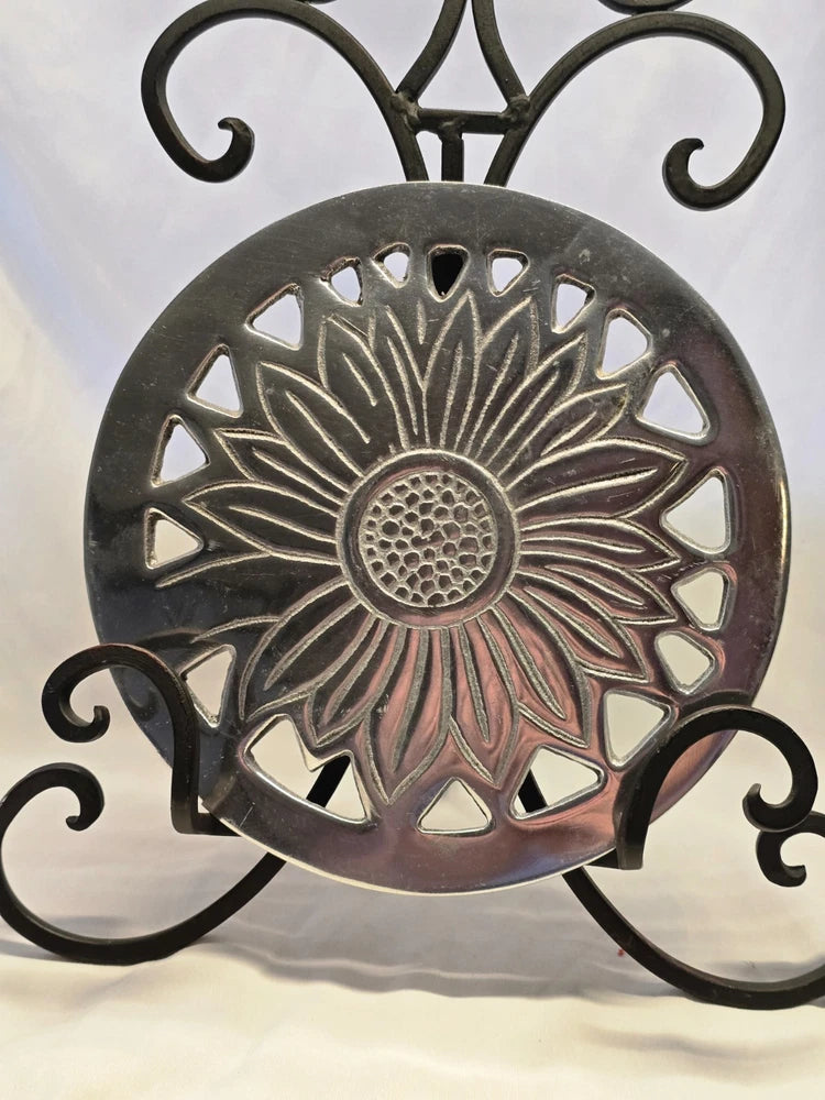 7.5-inch round sunflower trivet with dark metal openwork petals and circular center