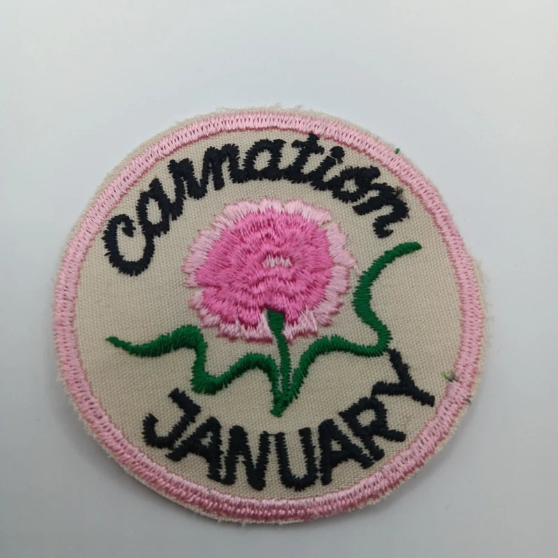 Pink carnation sew-on applique patch with 'January' text