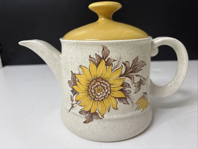 Sunflower stoneware teapot with speckled white body, yellow lid, and side handle