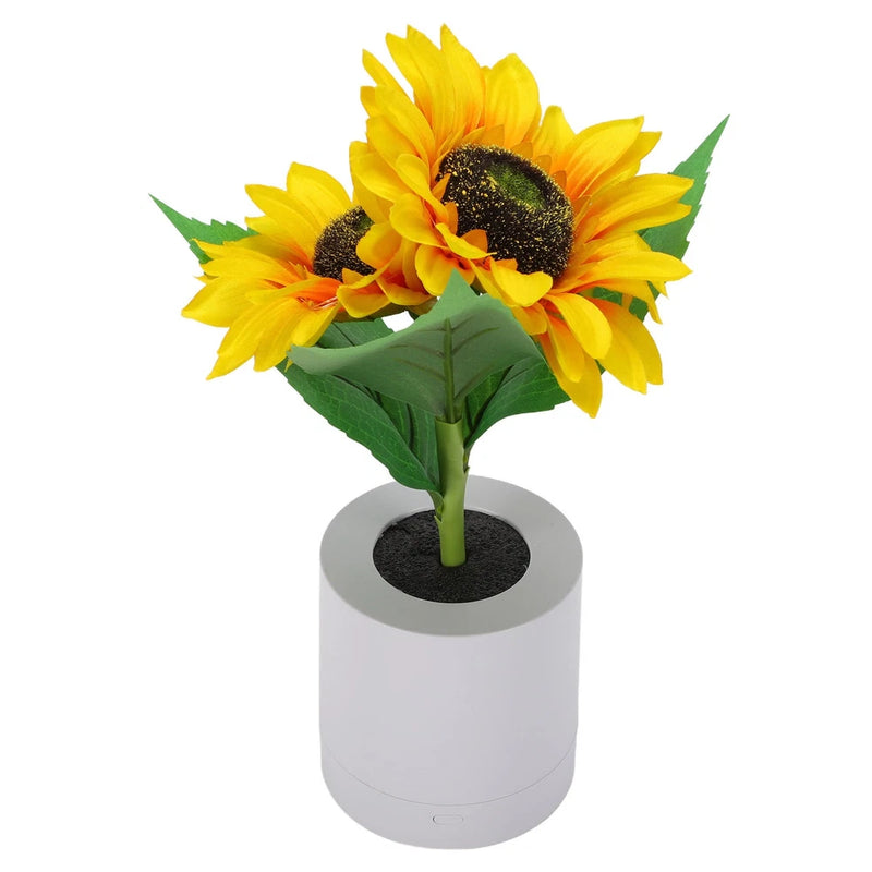 Artificial sunflower table lamp with yellow petals and green leaves on white base