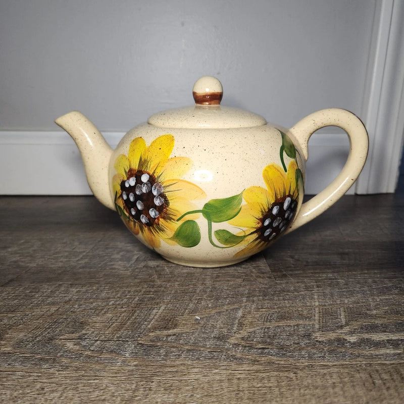 Ceramic stoneware teapot with sunflower floral design and curved spout, knob lid