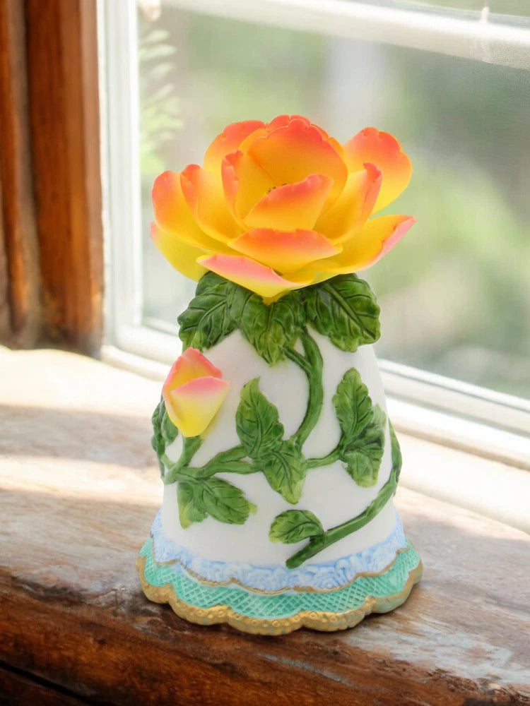 Ceramic mini peony flower bell with colorful pink-yellow petals and green leaves, white base