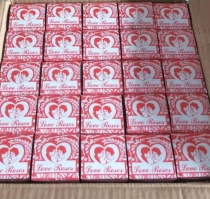 Boxed Love Roses glass tubes, many red and white cartons with heart logo