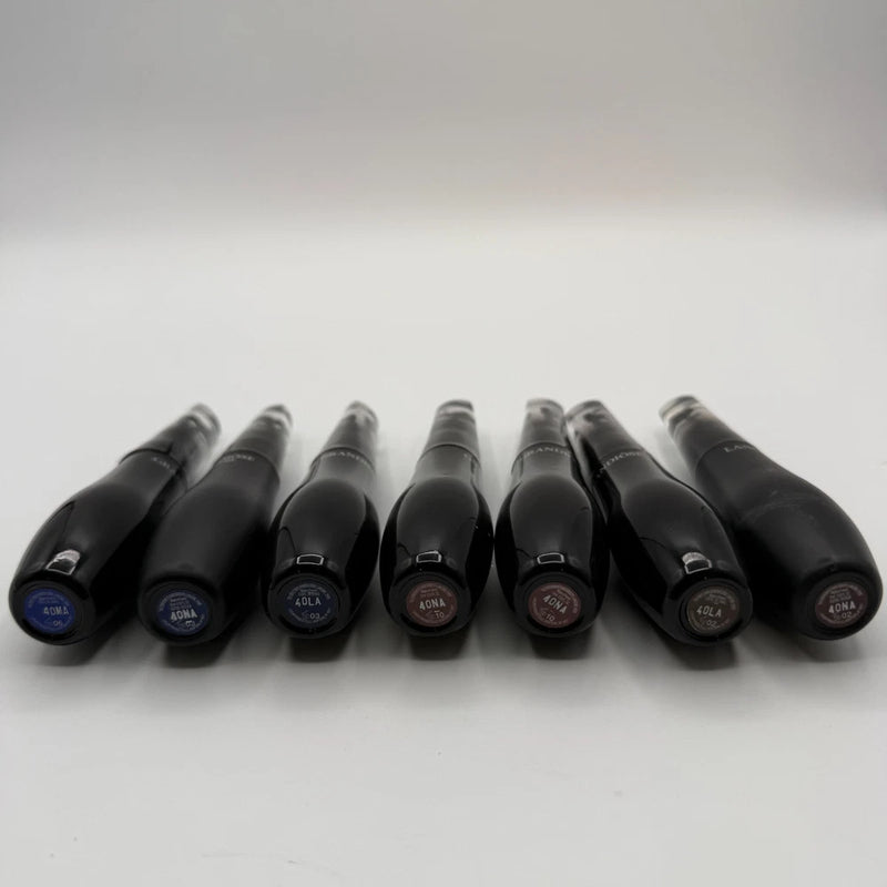Mascara tubes assortment with dark caps and colored accent labels