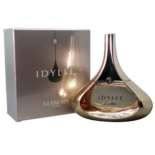 Idylle eau de parfum spray with gold-toned glass bottle, amber liquid, and gift box