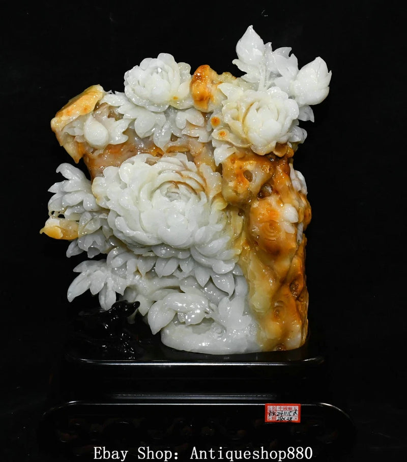 White jade peony carving with orange-brown veined stone, decorative statue