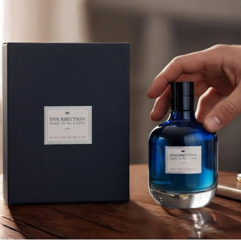 Blue glass eau de parfum bottle with black cap and label, with matching gift box