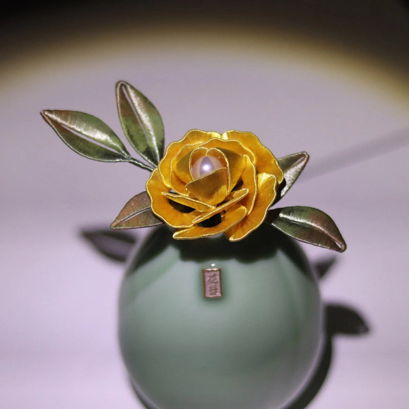Peony flower brooch with gold petals, pearl center, and leaf accents