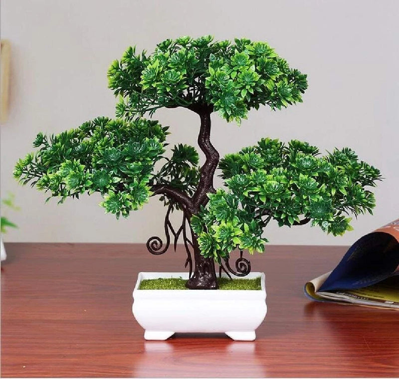 Artificial bonsai tree with green foliage in a white plastic square pot
