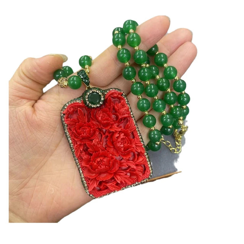 Red floral rectangle pendant necklace with green bead chain and round green stone