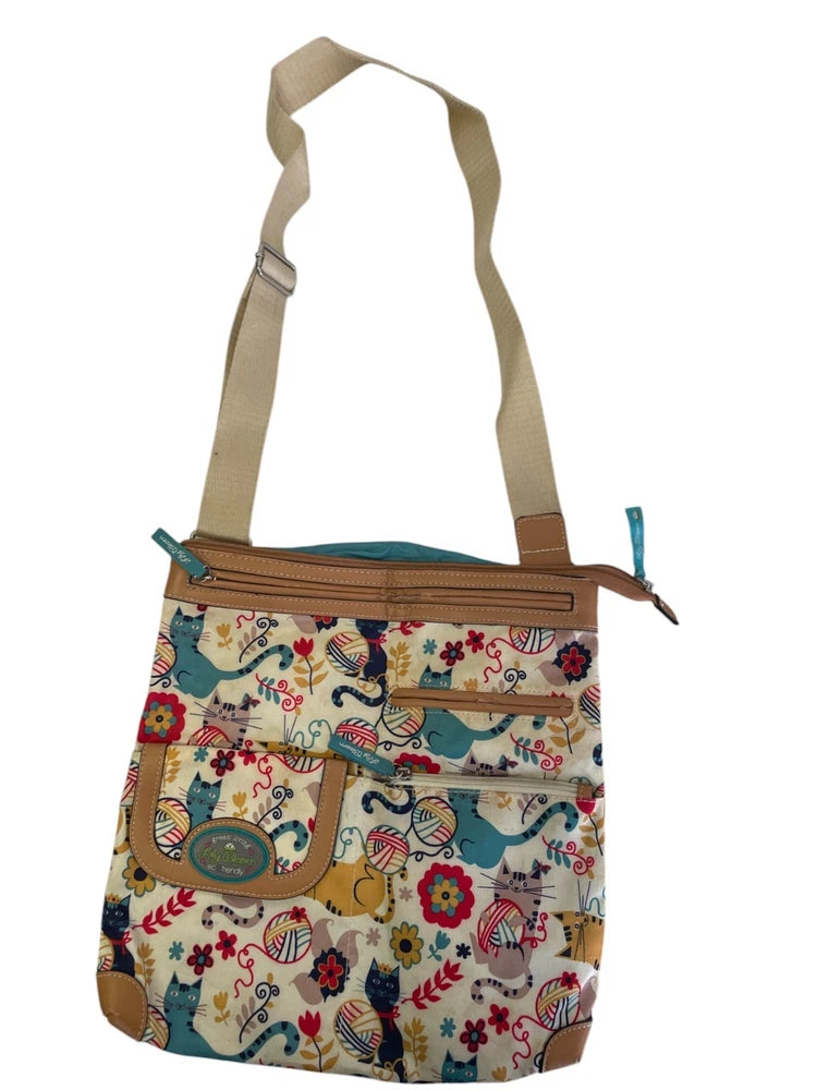 Printed cat crossbody bag with brown leather trim, teal lining, adjustable shoulder strap
