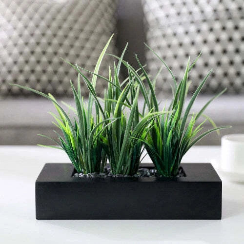 Artificial green grass plants in black rectangular planter pot