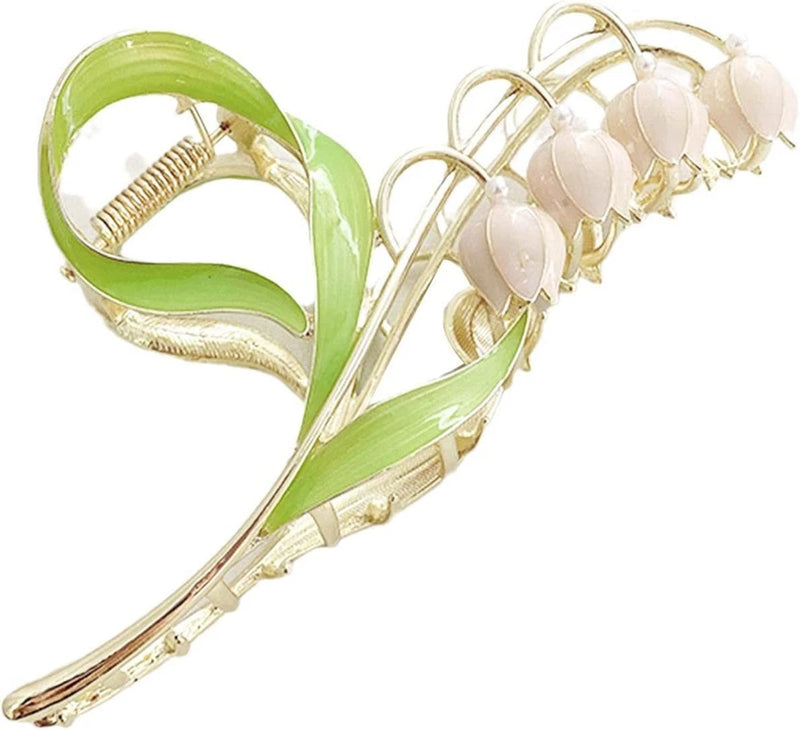 Large metal claw hair clip with lily-of-the-valley flowers and green leaf accents