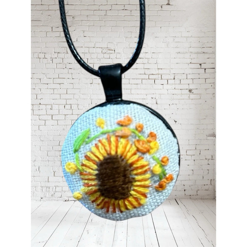 Round sunflower embroidery charm pendant on black cord necklace