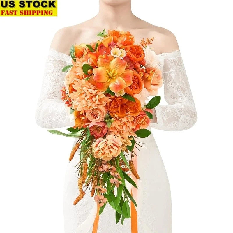 Faux flower bouquet with orange and peach roses, lilies, and green leaves