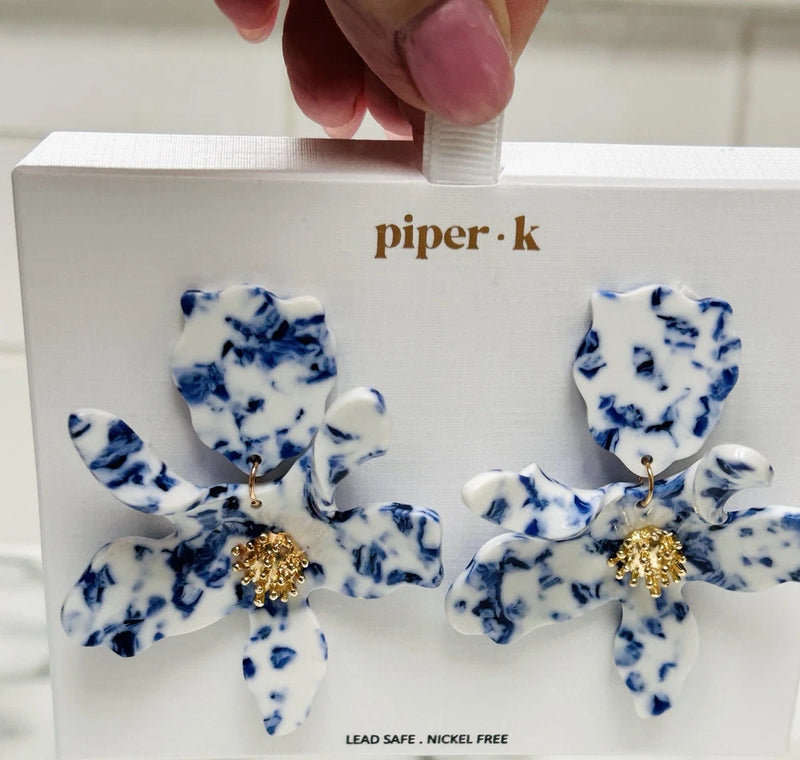 Piper K dangling earrings with blue-and-white floral petals and gold-tone center