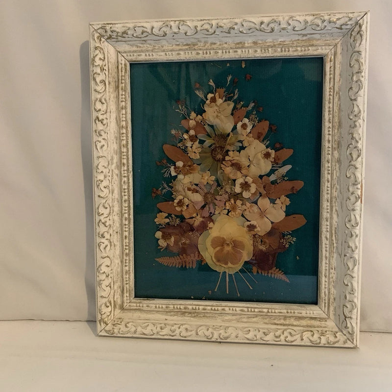 Pressed dried flower wall art in ornate light wood frame with glass cover