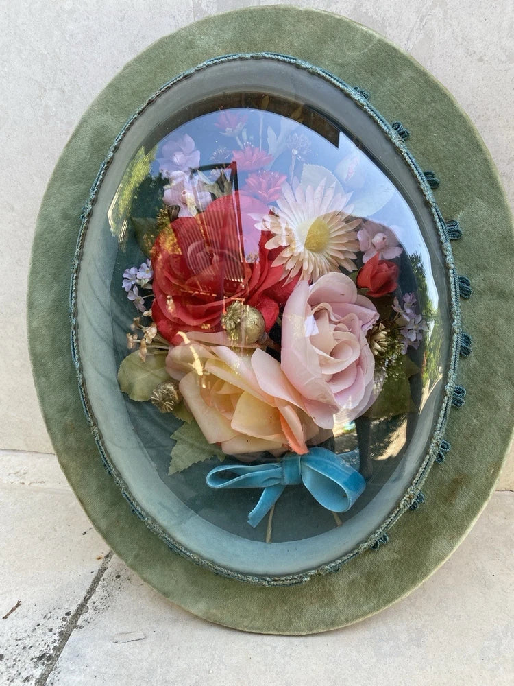 Oval glass dome dried flower wall potpourri with pastel blooms and blue ribbon
