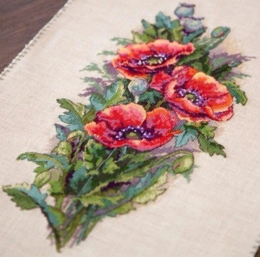 Cross-stitch pattern fabric with vintage bouquet of red poppies and green leaves