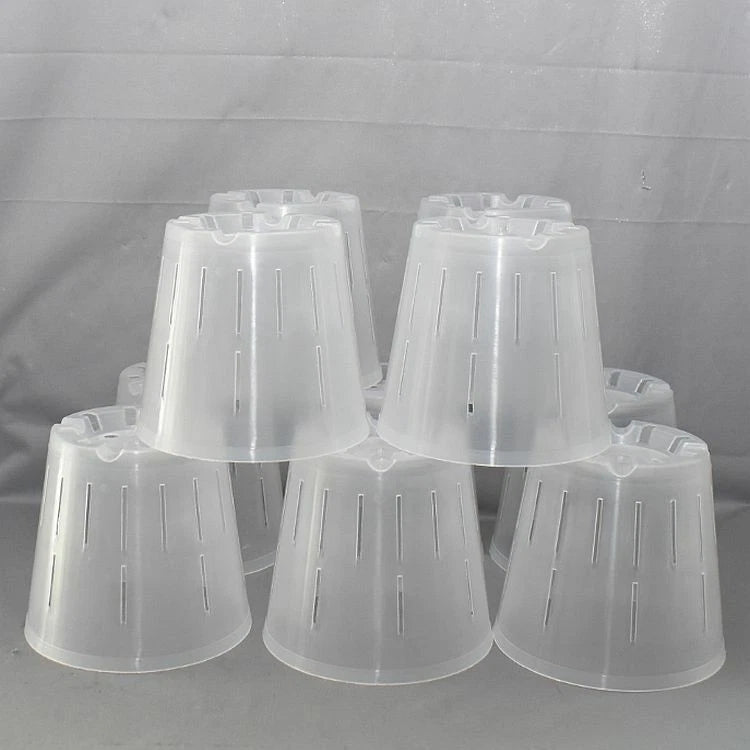 Clear round plastic orchid pots with drainage slits, stack of multiple pots