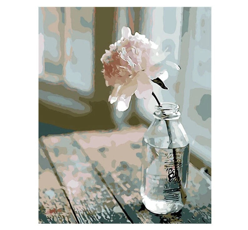 Paint by numbers canvas with white peony flowers in a clear glass vase