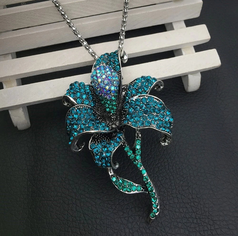 Teal blue rhinestone lily pendant necklace with crystal-like flower charm and chain