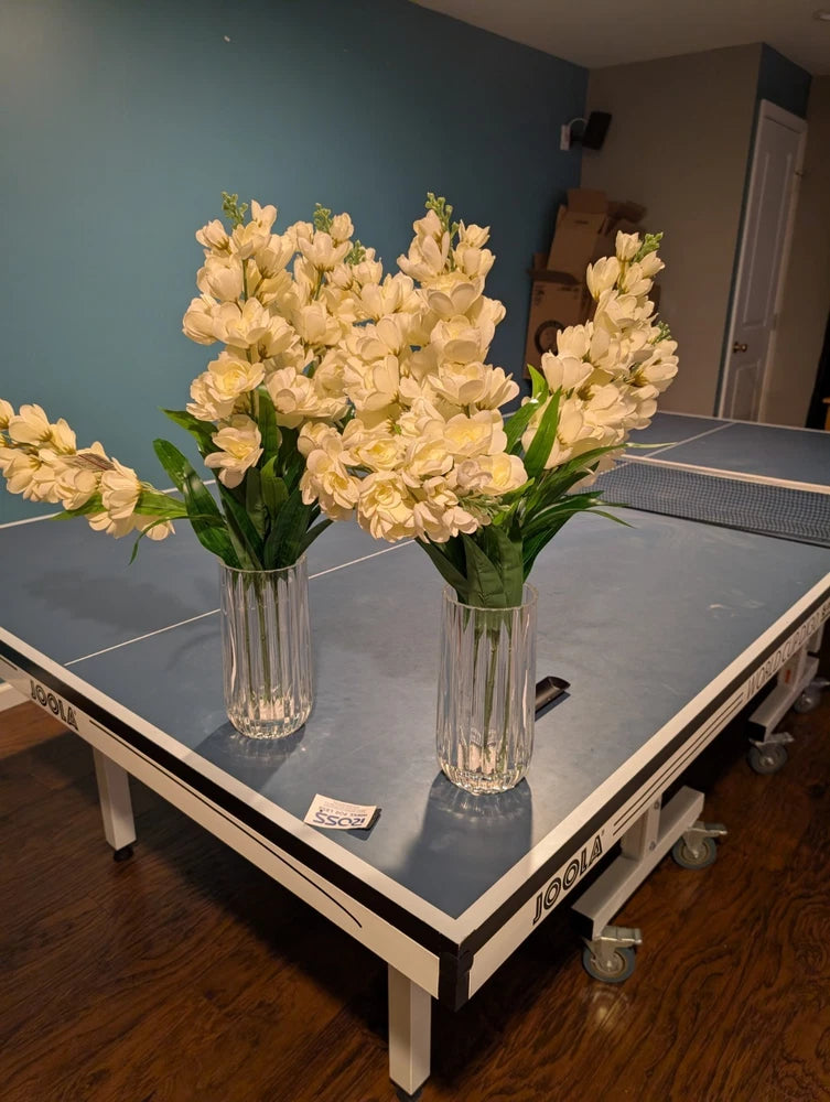 Artificial peony flower arrangement in clear ribbed vases, creamy yellow faux blooms