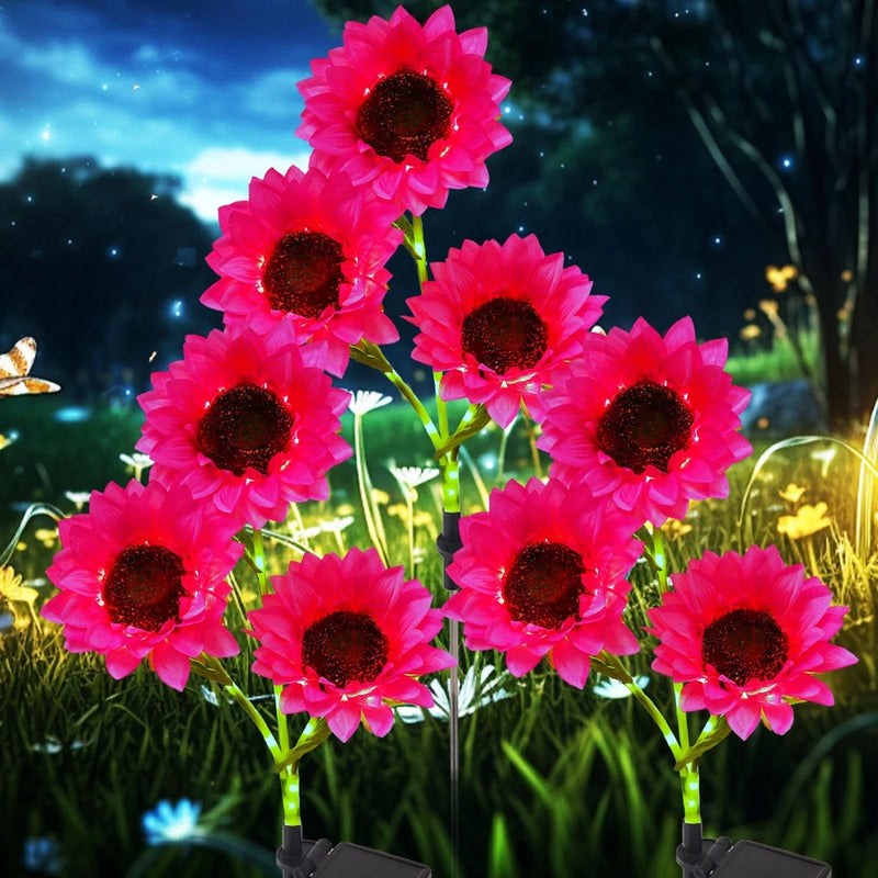 Colorful solar flower lights with pink blossoms on metal stakes
