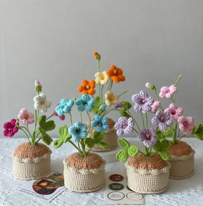 Handmade crochet flower pot decor with crocheted sunflower and pastel blossoms