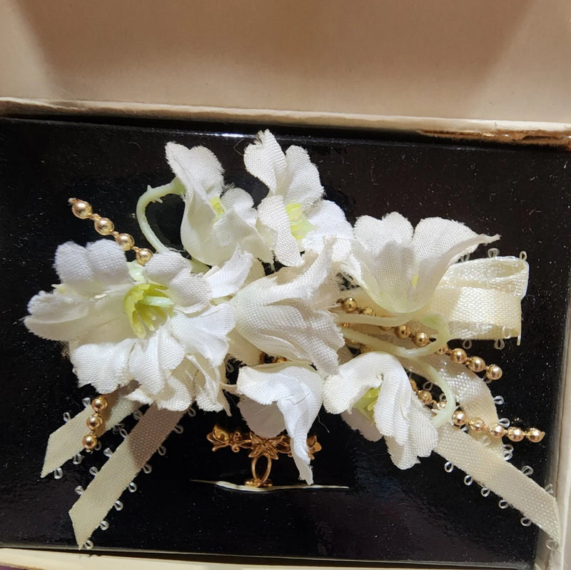 White lily flower pin brooch with gold cross, pearls, and ribbon details