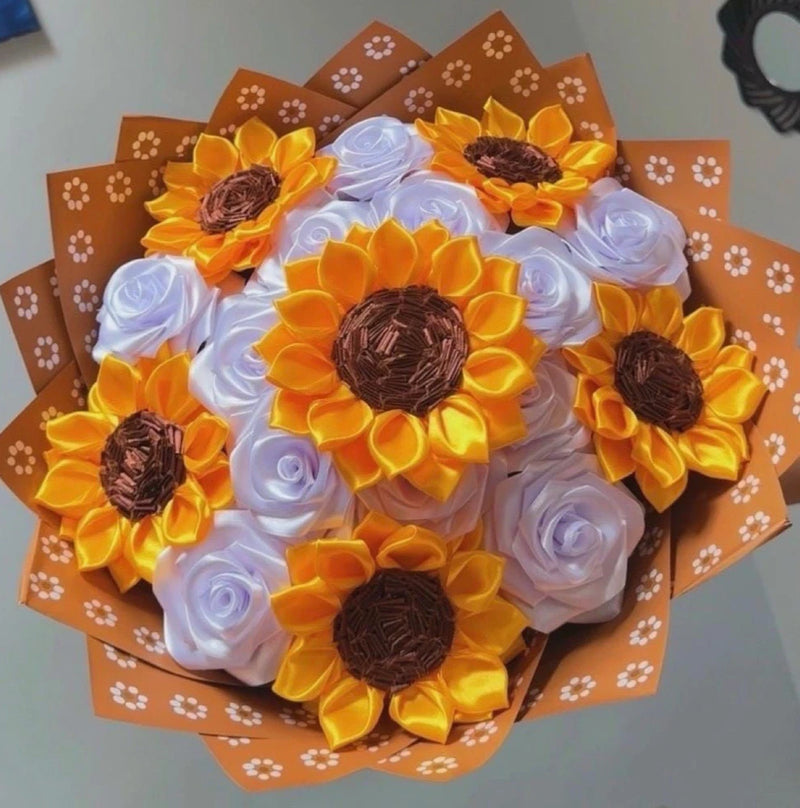 Eternal flower bouquet with yellow sunflowers and white satin roses, wrapped in orange paper